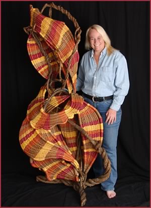 Tina Puckett with her freestanding basket sculpture Dancing