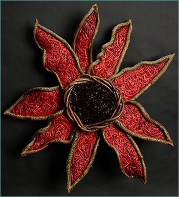 Wild Gerbera Red Daisy, sculptural work woven from reeds by basket artist Tina Puckett