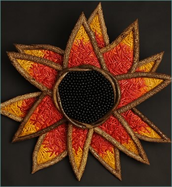 Colorful Sunflower, a sunflower wall sculpture woven by basketry artist Tina Puckett of Winsted, CT